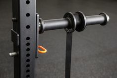 an orange object is attached to the side of a black rack