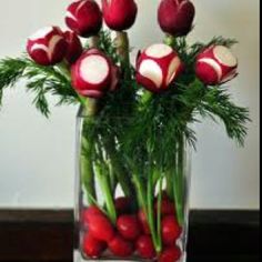 a vase filled with red and white flowers