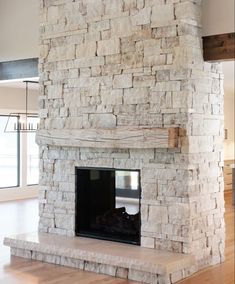 a large stone fireplace in the middle of a living room