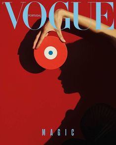 a woman's hand holding an object in front of her face on the cover of a magazine