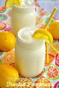 two mason jars filled with lemonade and topped with straws on a colorful tablecloth