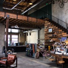 the inside of a bike shop with lots of bikes on display and furniture in it