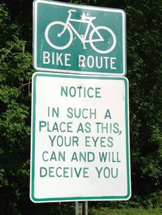 a green and white sign that says bike route