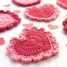 crocheted hearts are arranged on a table