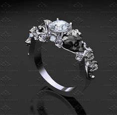 a black and white diamond engagement ring with roses on the side, set in 18k white gold