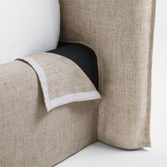 a close up view of the corner of a couch with pillows on top of it