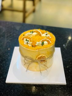 a cake with oranges and cream is on a plate