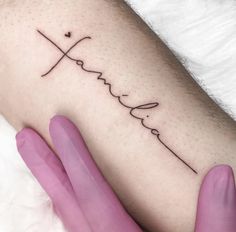 a woman's arm with the word faith written in cursive writing on it