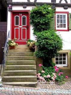 a red door and some steps in front of a house