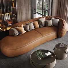 a living room filled with lots of furniture next to a large glass window and bookshelf