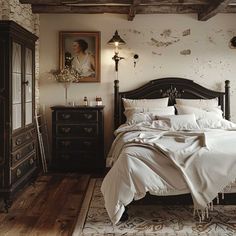 a bed with white sheets and pillows in a bedroom next to a painting on the wall