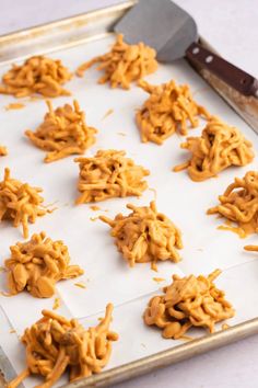 the cookies are ready to be baked on the baking sheet with a spatula next to them