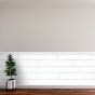 an empty room with a plant on the table in front of it and a white wall