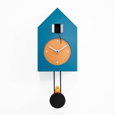 a clock that is on the side of a wall with a blue face and black hands