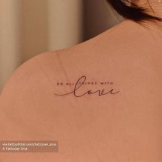 the back of a woman's shoulder with an inscription that reads, do all things with love