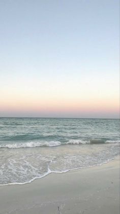 an ocean beach with waves coming in to shore