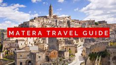 a red sign that says matera travel guide in front of an old cityscape