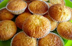 a green plate filled with muffins on top of a table