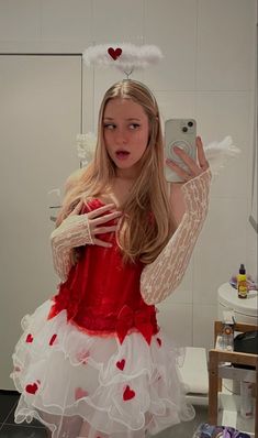 a woman in a red and white dress taking a selfie