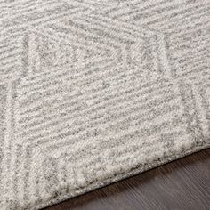 a close up of a rug on a wooden floor with a wood flooring surface