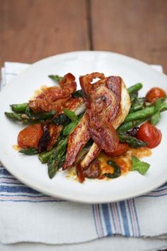 a white plate topped with meat and veggies