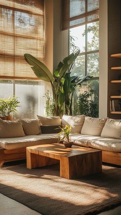 a living room filled with lots of furniture next to a large window covered in bamboo blinds