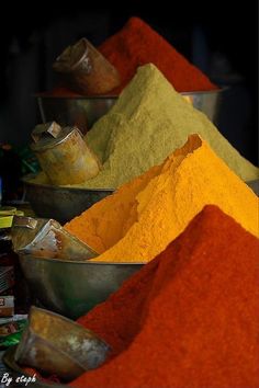 several bowls filled with different colored powders