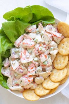 a white bowl filled with salad and crackers