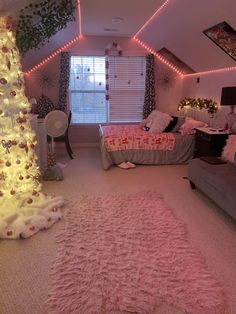 a bedroom decorated in pink and white with lights on the ceiling, bedding and rugs