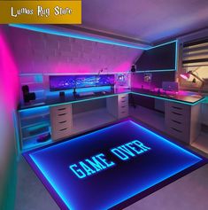 a gaming room with neon lights on the floor and an illuminated game over sign in the center