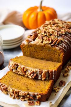 sliced loaf of pumpkin bread with pecans on top