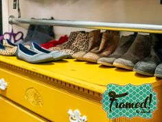 several pairs of shoes are lined up on a yellow dresser with the word fromed painted on it