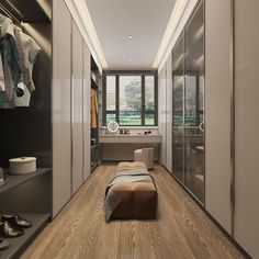 a bedroom with wooden flooring and closets next to a window filled with clothes