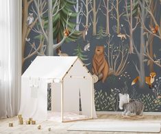 a child's room with woodland animals and trees on the wall, along with a play tent