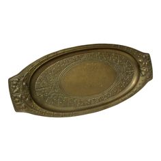 an oval metal tray with ornate designs on it