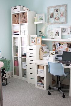 a desk with a laptop computer sitting on top of it next to a book shelf