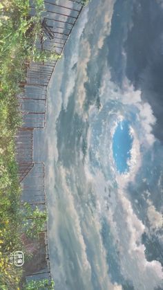 the sky and clouds are reflected in the water