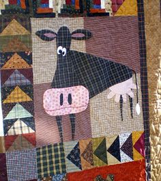 a patchwork quilt with a cow on it