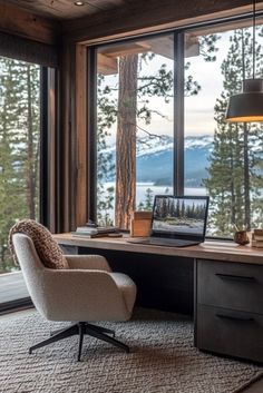 an office with a desk, chair and large window overlooking the lake in front of it