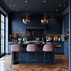 a kitchen with blue walls and wooden floors, two bar stools in front of the island