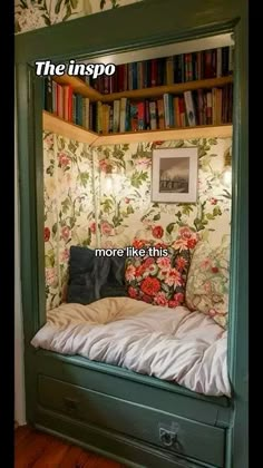 there is a bed in the room with bookshelves on the wall behind it