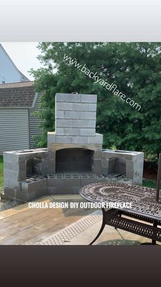 an outdoor fireplace made out of cinder blocks