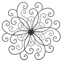 a metal wall decoration with swirly designs