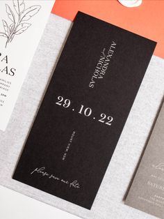 the wedding stationery is laid out on top of each other