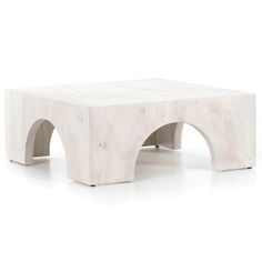 a white coffee table with an arch design