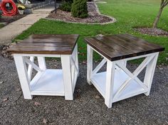 two white and brown tables sitting on top of gravel