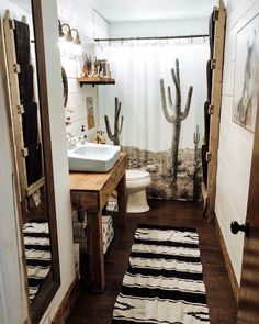 a bathroom with a cactus shower curtain next to a sink