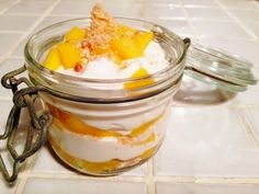 a glass jar filled with food on top of a white tiled floor