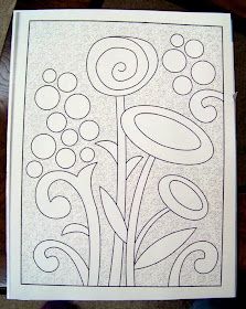 a coloring book with flowers and swirls on the cover, sitting on a table