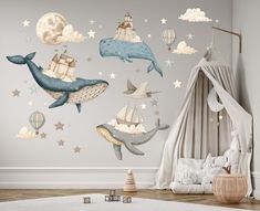 a child's bedroom with a wall mural featuring whales, stars and hot air balloons